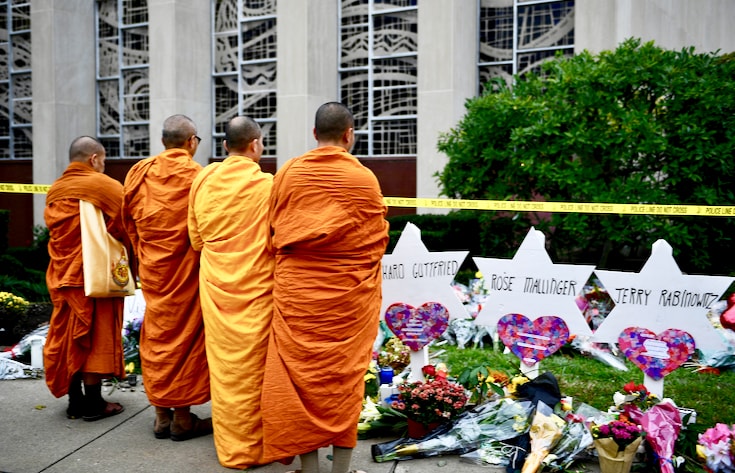 Monks standing at memorial outside Tree of Life synagogue.
