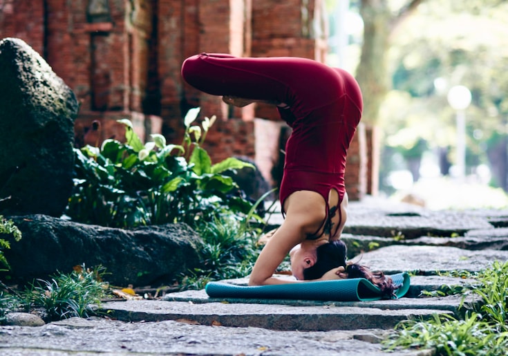 Yoga practitioner in upside down meditation posture.
