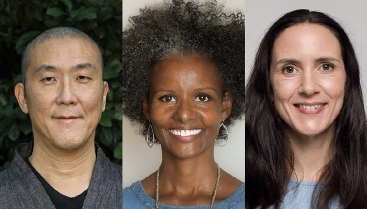 A photo of three people. The man on the left is bald and wearing a grey top. The woman in the middle has on hoop earrings and a necklace. The woman on the right has long hair and a blue shirt.
