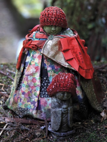 A statue covered in children's clothing.