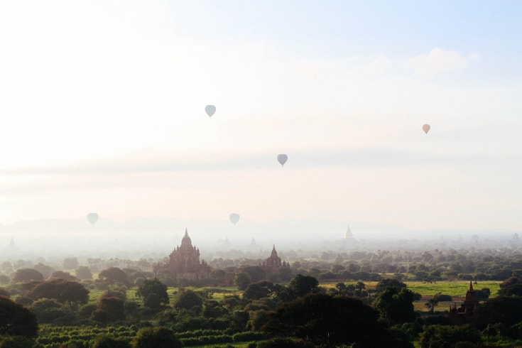 Landscape filled with stupas, sky filled with hot air balloons