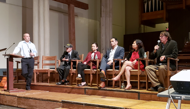 A panel speaking ona stage