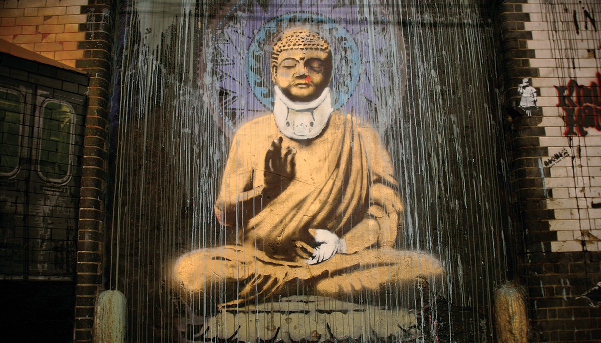 A photo of a painting of Buddha with a neck brace. It is street art.