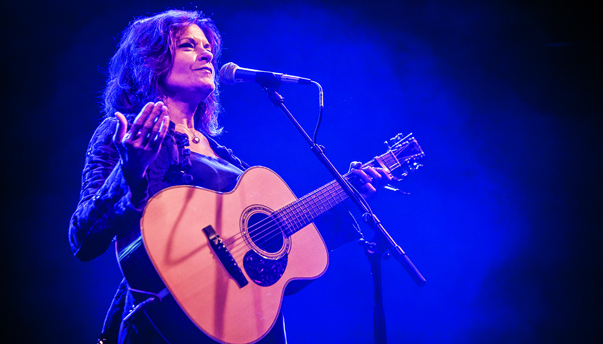 Rosanne Cash playing guitar onstage