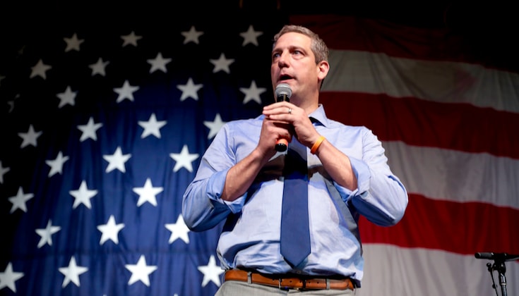 Tim Ryan speaking in front of an American flag