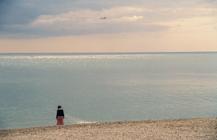 Person on a beach at sunset.