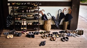 Pile of shoes on a rack outside meditation hall