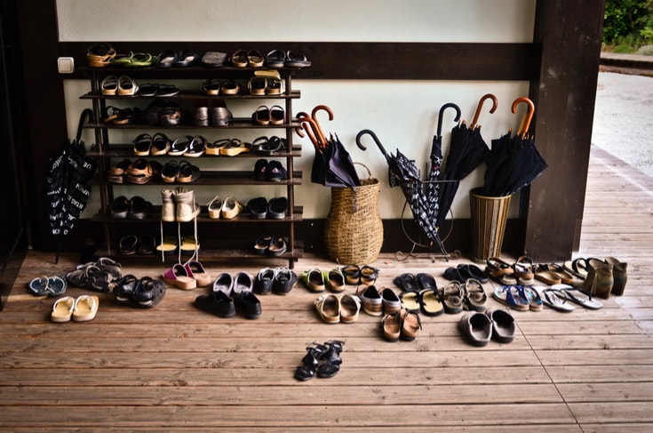 Pile of shoes on a rack outside meditation hall