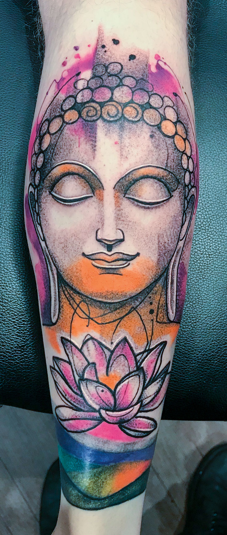 A tattoo of a face over a blossom flower.
