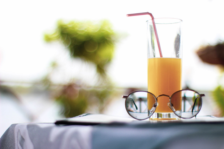 Glass of orange juice on table
