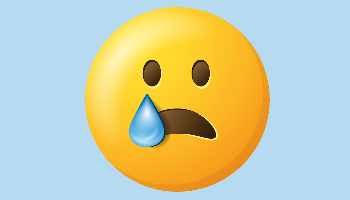 An emoji face of someone with one tear.