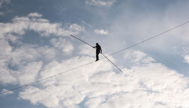 Image of person walking on a tightrope