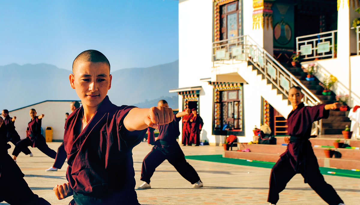 Nuns practicing self defence in courtyard