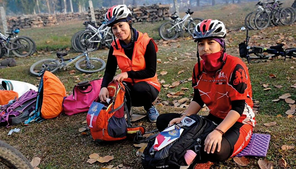 Two nuns in cycling gear packing their bags