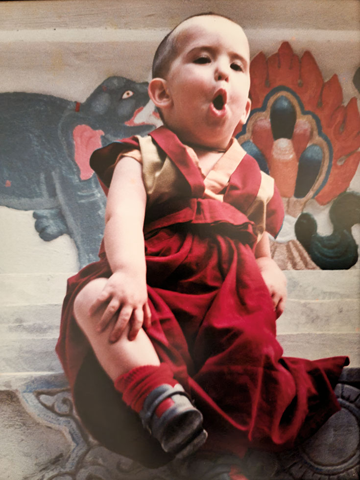 A young boy in buddhist robes.