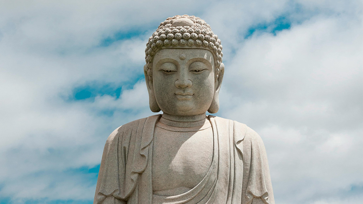 buddha statue against bright blue sky