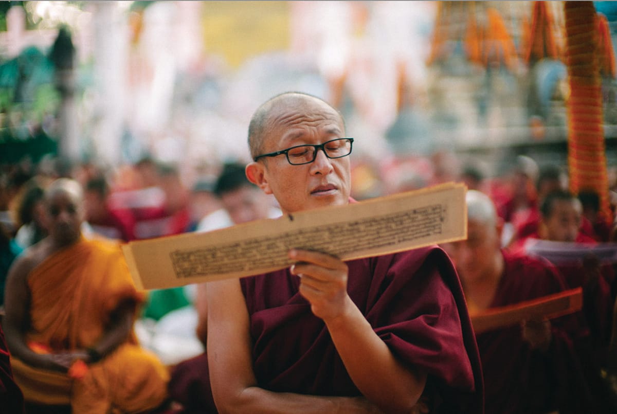 Dzongsar Khyentse Rinpoche reading a Buddhist text.