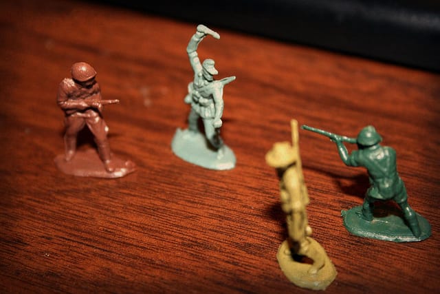 Toy soldiers posed to fight each other.