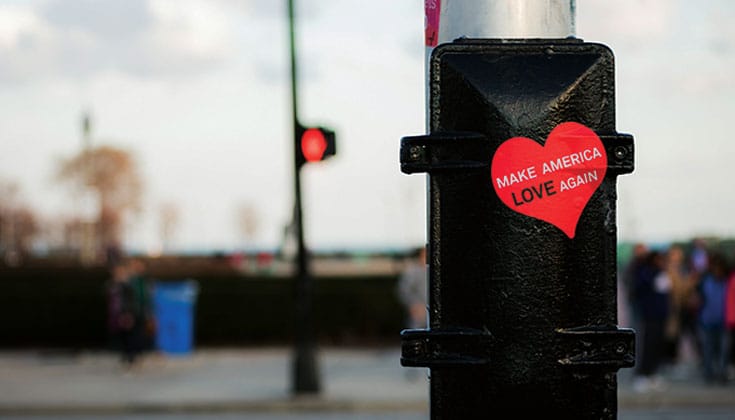 A sticker on a post that reads Make America Love Again