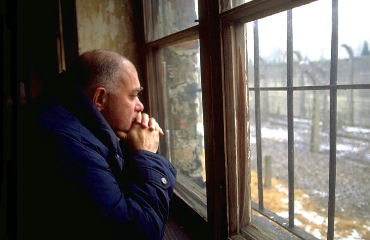 Bernie Glassman staring out of a window at Auschwitz.