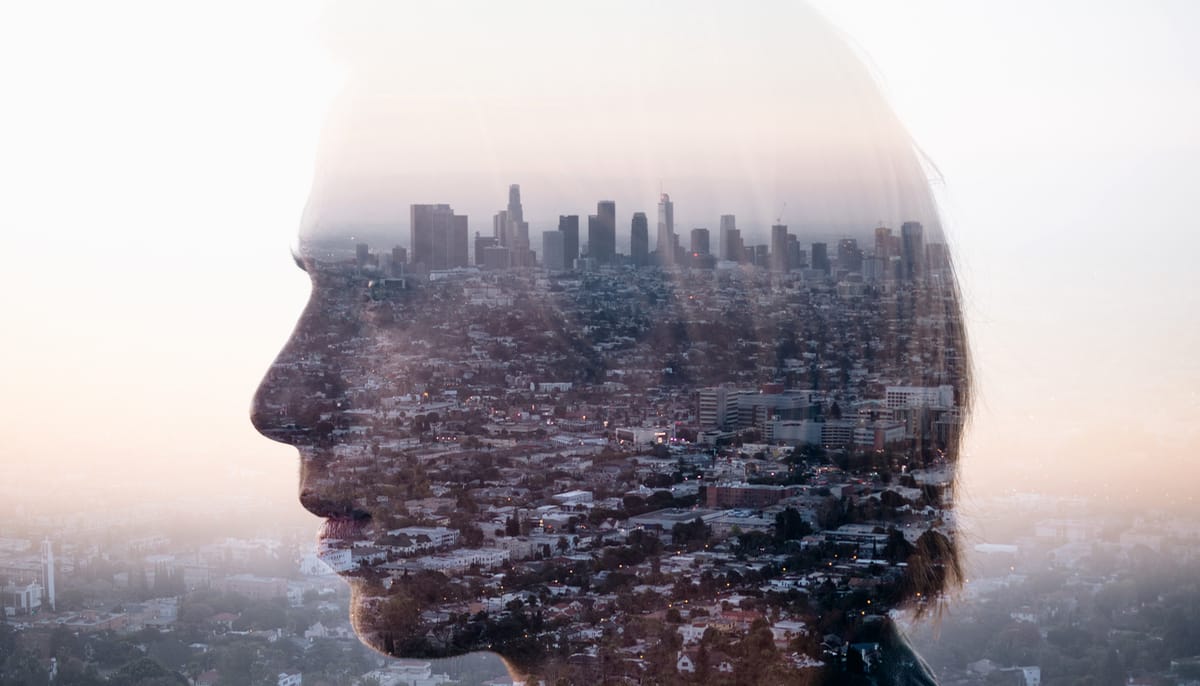 City reflected over a woman's face.