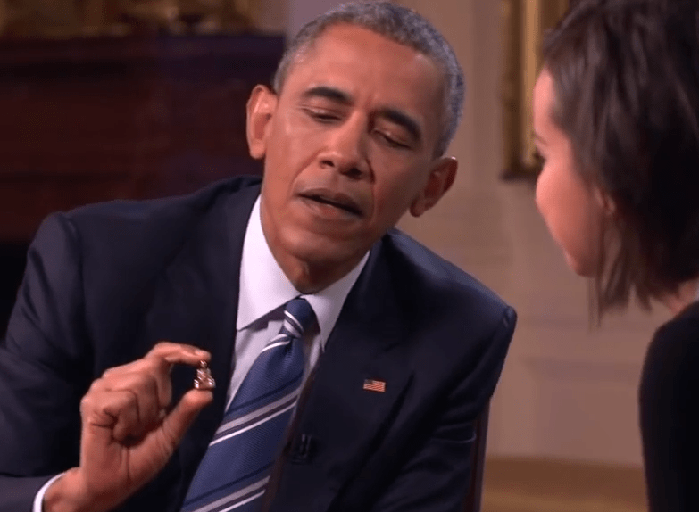 Obama, in White House video, shows the tiny Buddha statuette he  carries around all the time.