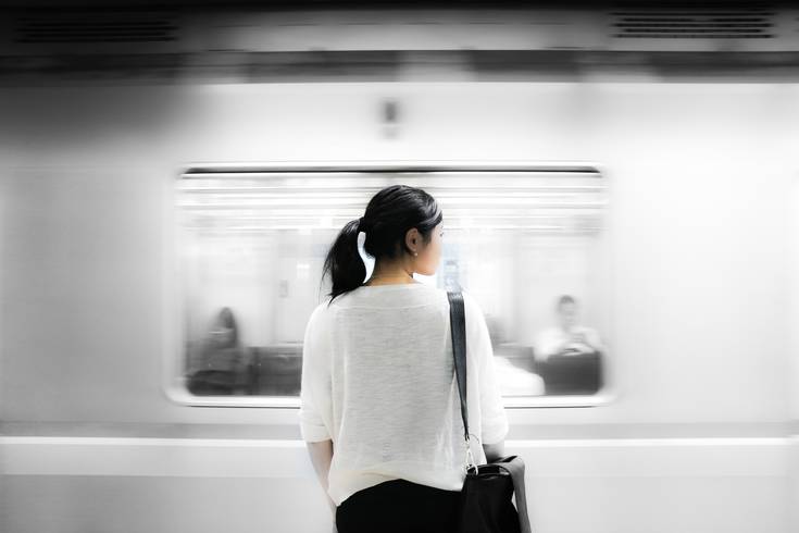 Woman standing in front of a subway.