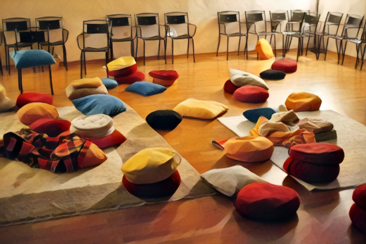 Painting of meditation cushions scattered on floor.