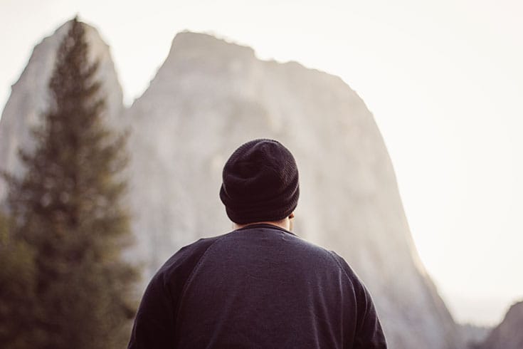 Man standing in front of a mountain.