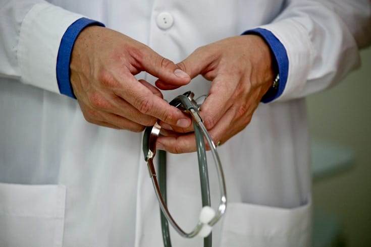 Doctor holding stethoscope.