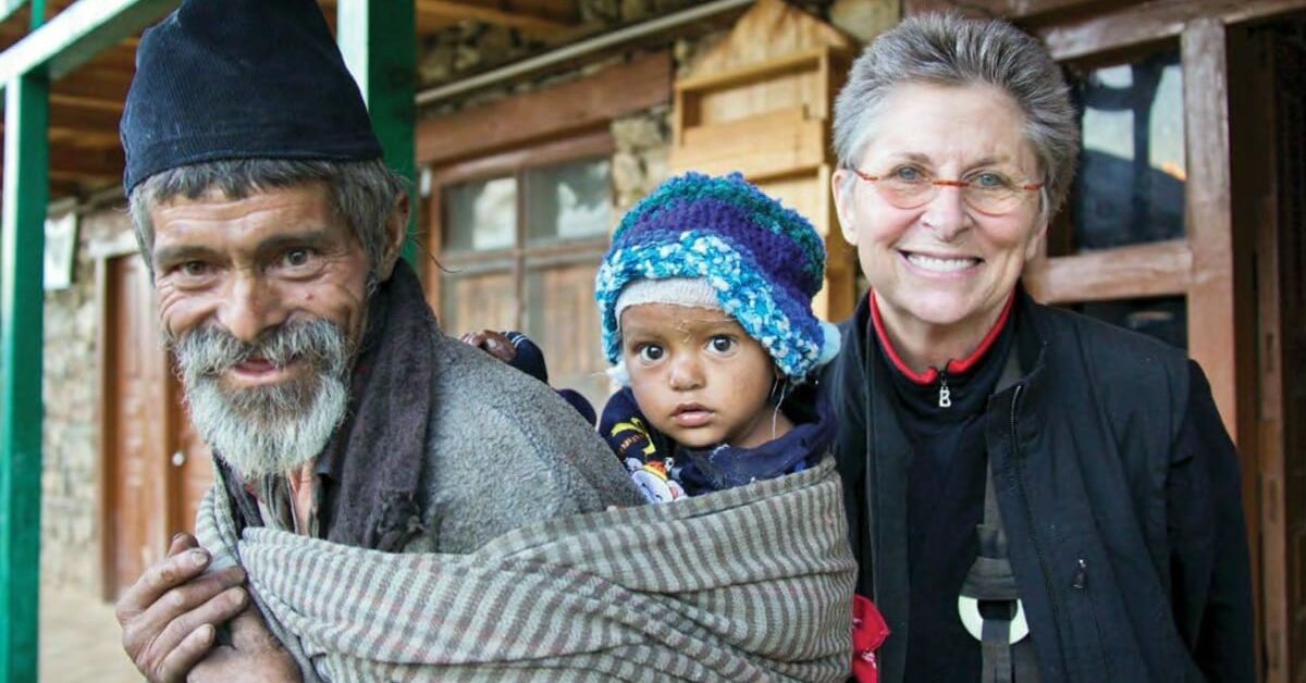 Man with baby on his back, with Roshi Joan Halifax.