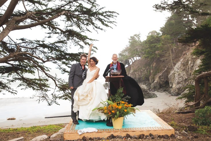 Rachel Nuemann at the wedding alter with her husband and a priest.