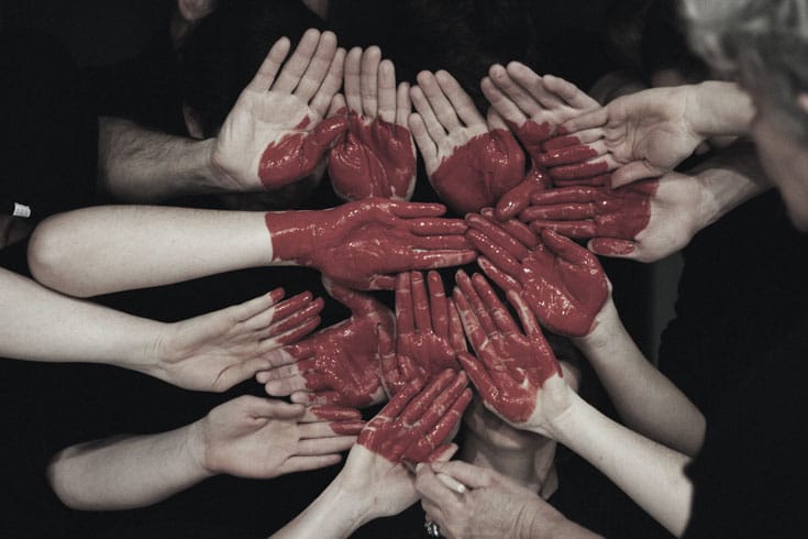 A heart made of painted hands.