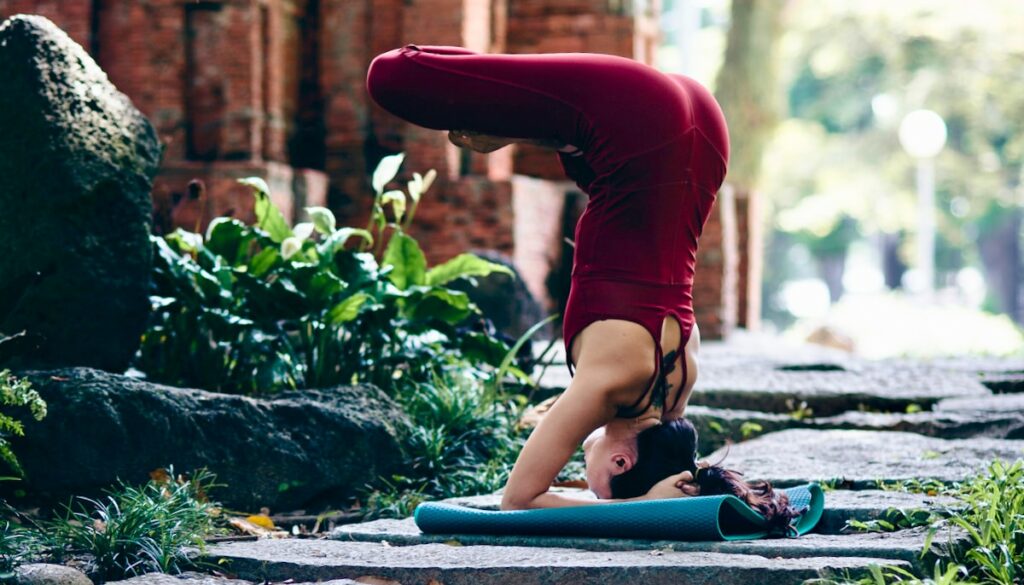 Yoga practitioner in upside down meditation posture.