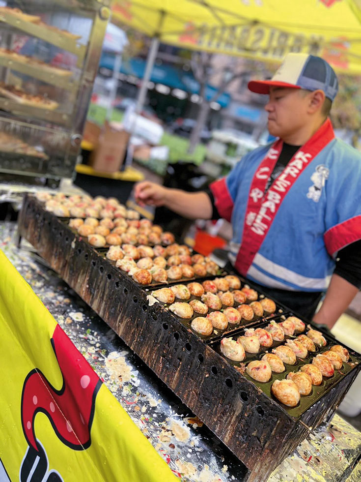 Karl Palma prepares takoyaki, a Japanese snack, at the Japan Festival occurring every year in Manhattan’s Upper West Side.