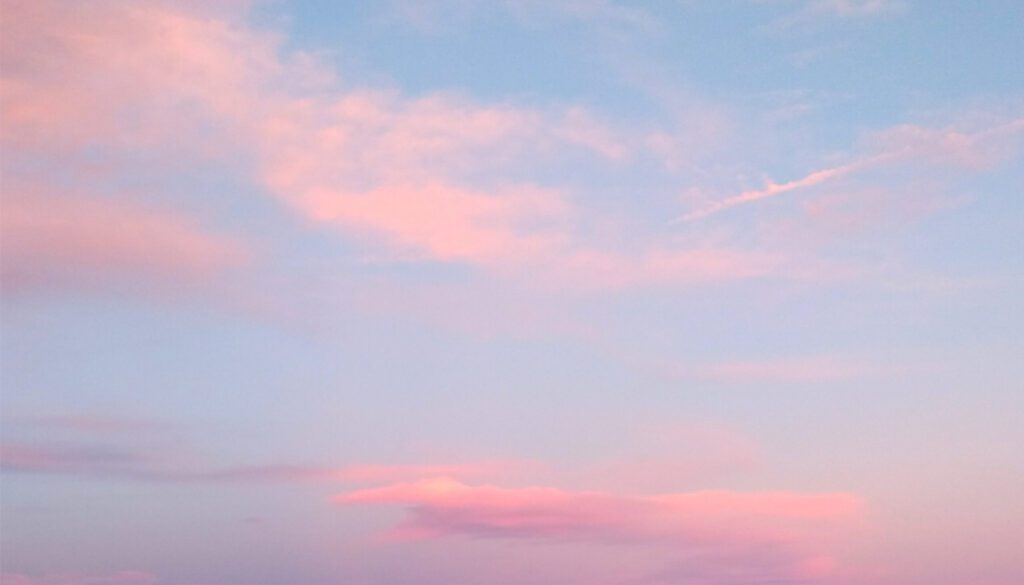 Pink clouds in blue sky