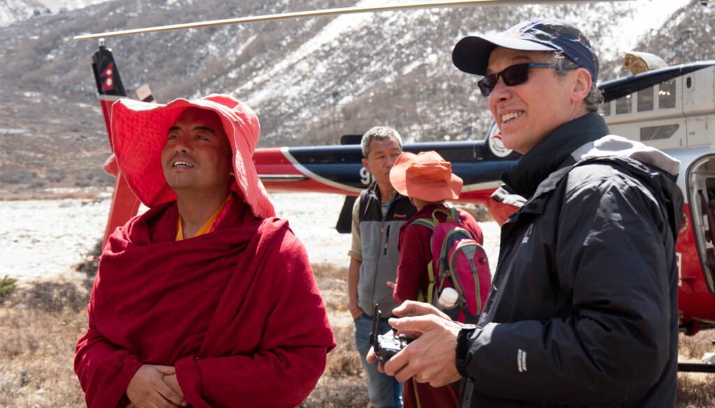 Mingyur Rinpoche and Paul McGowan in the mountains, looking at the scenery around them.