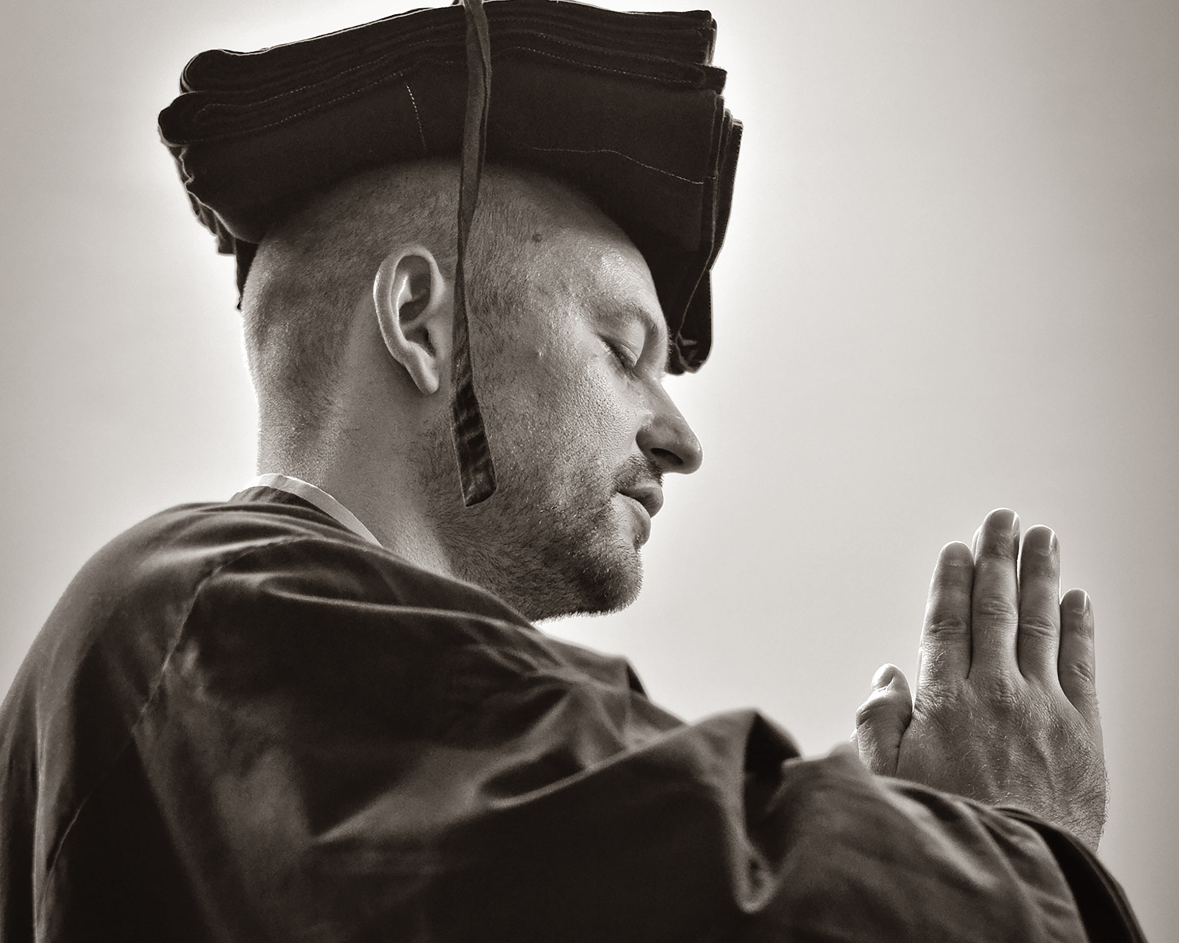 Man in Zen robes with hands in gassho