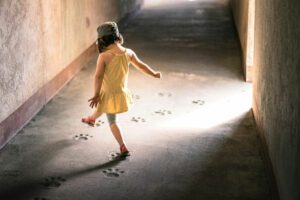 Child stepping in a sunbeam