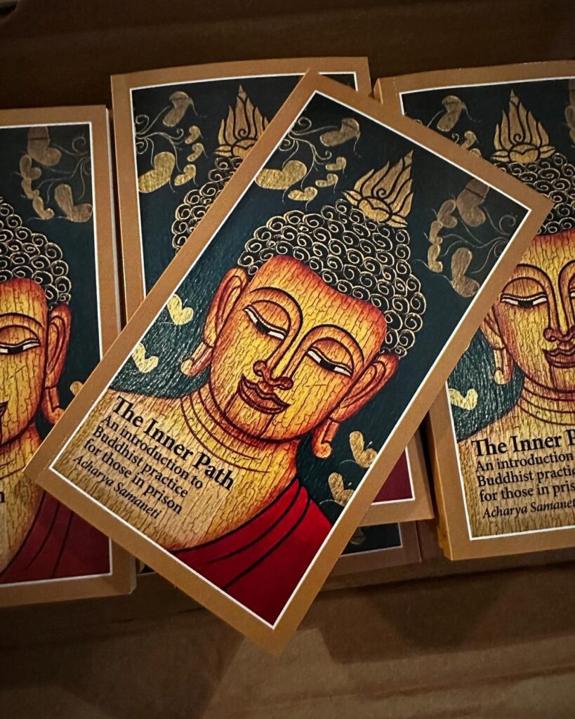 Copies of the book The Inner Path: An Introduction to Buddhist Practice for Those in Prison are seen.