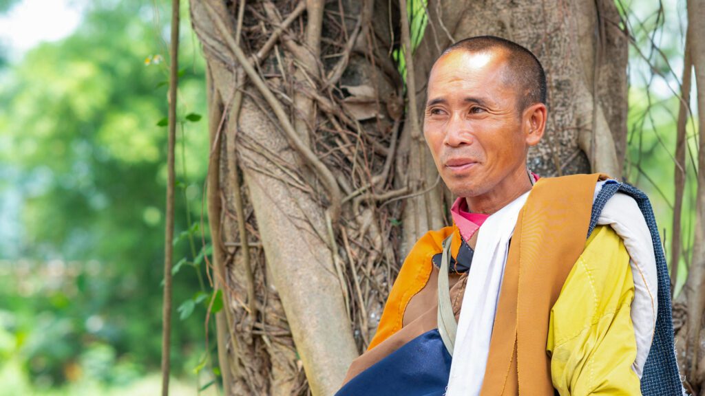 Vietnamese Buddhist monk, Thich Minh Tue, under a tree.